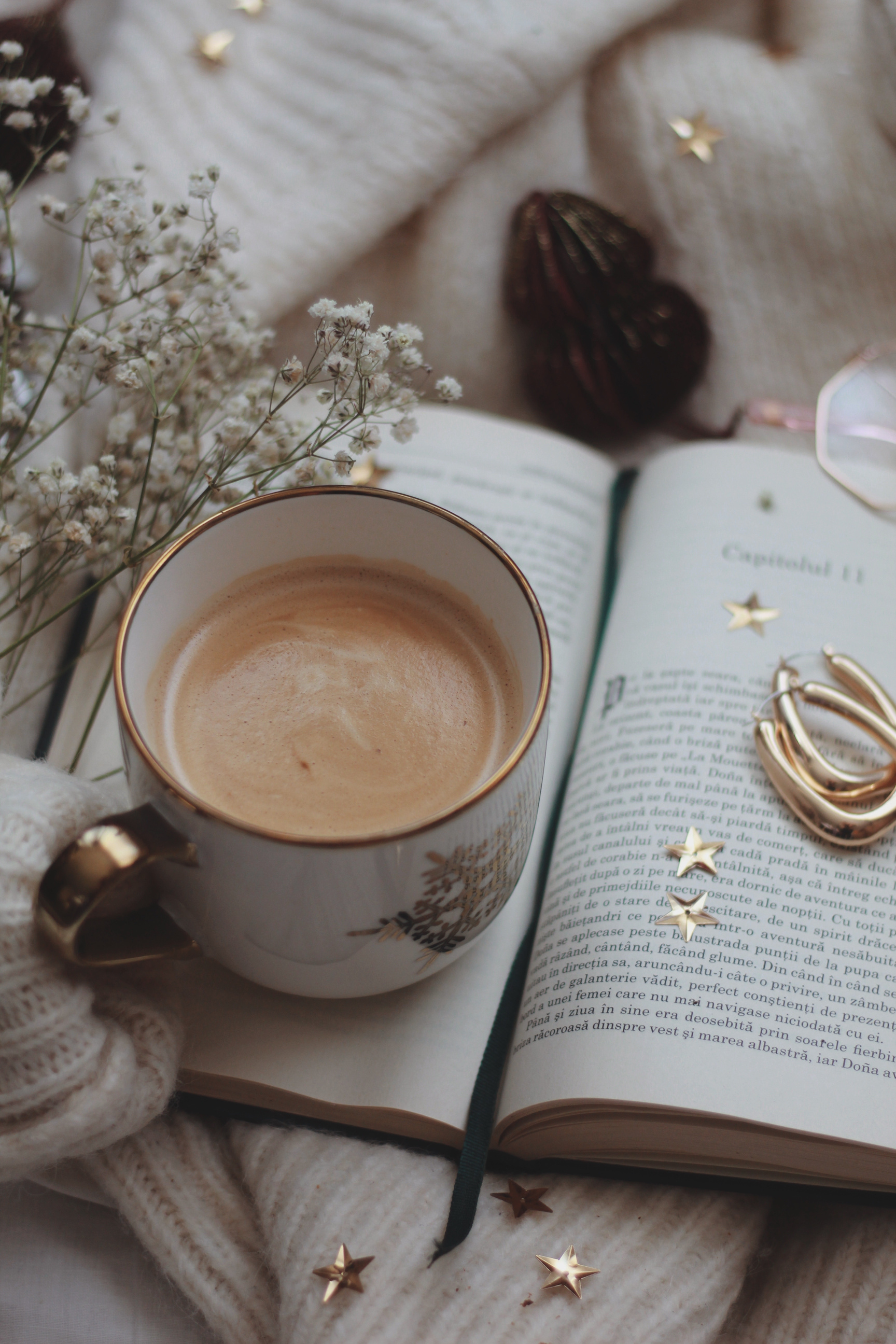 Open Book With Cup of Coffee and Flowers on Sweater